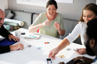 Colleagues laughing at photo across