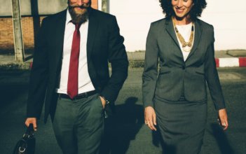 Man and woman in business attire walking next to each other