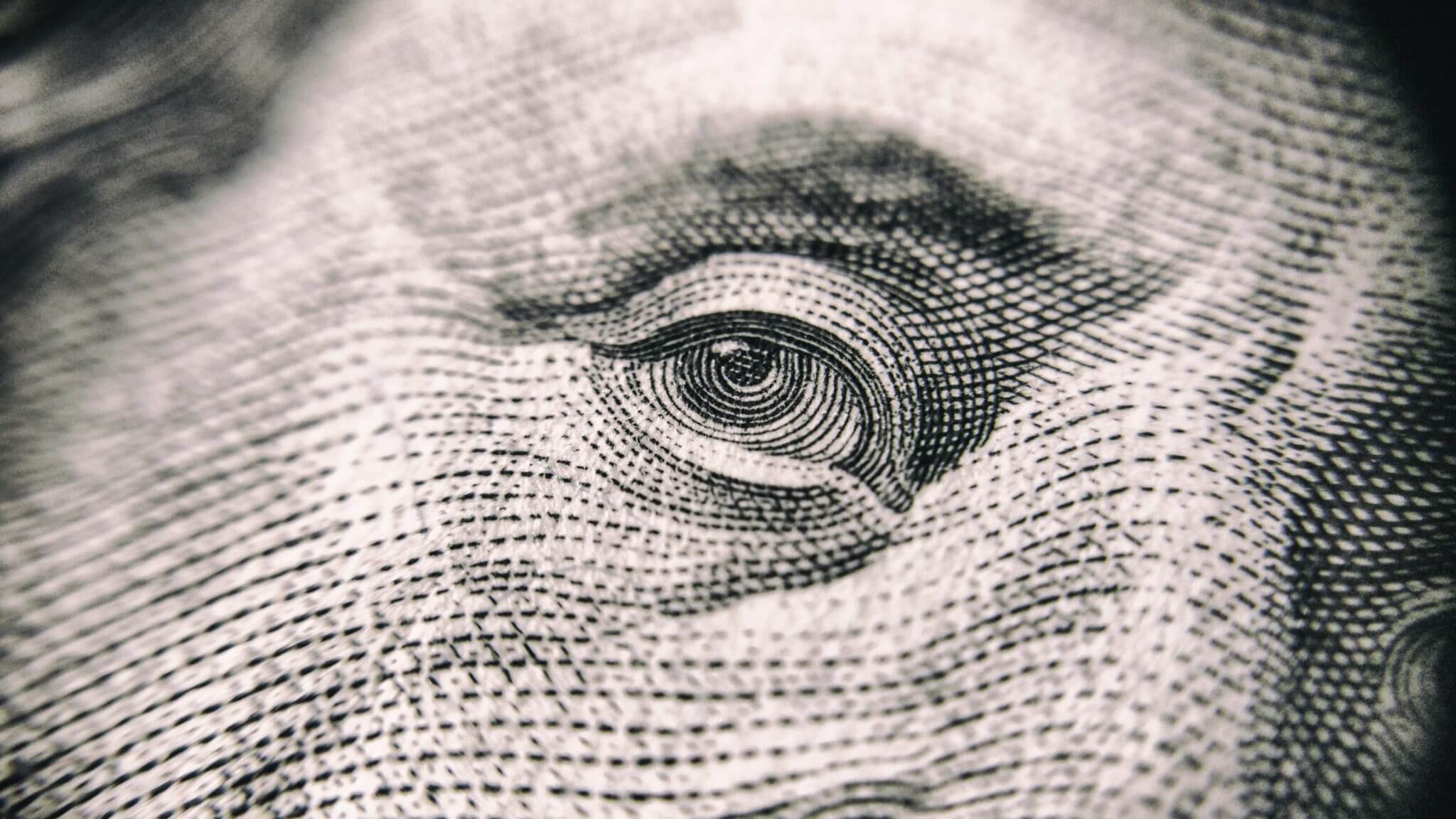 close up of bejamin franklin's eye on $100 bill