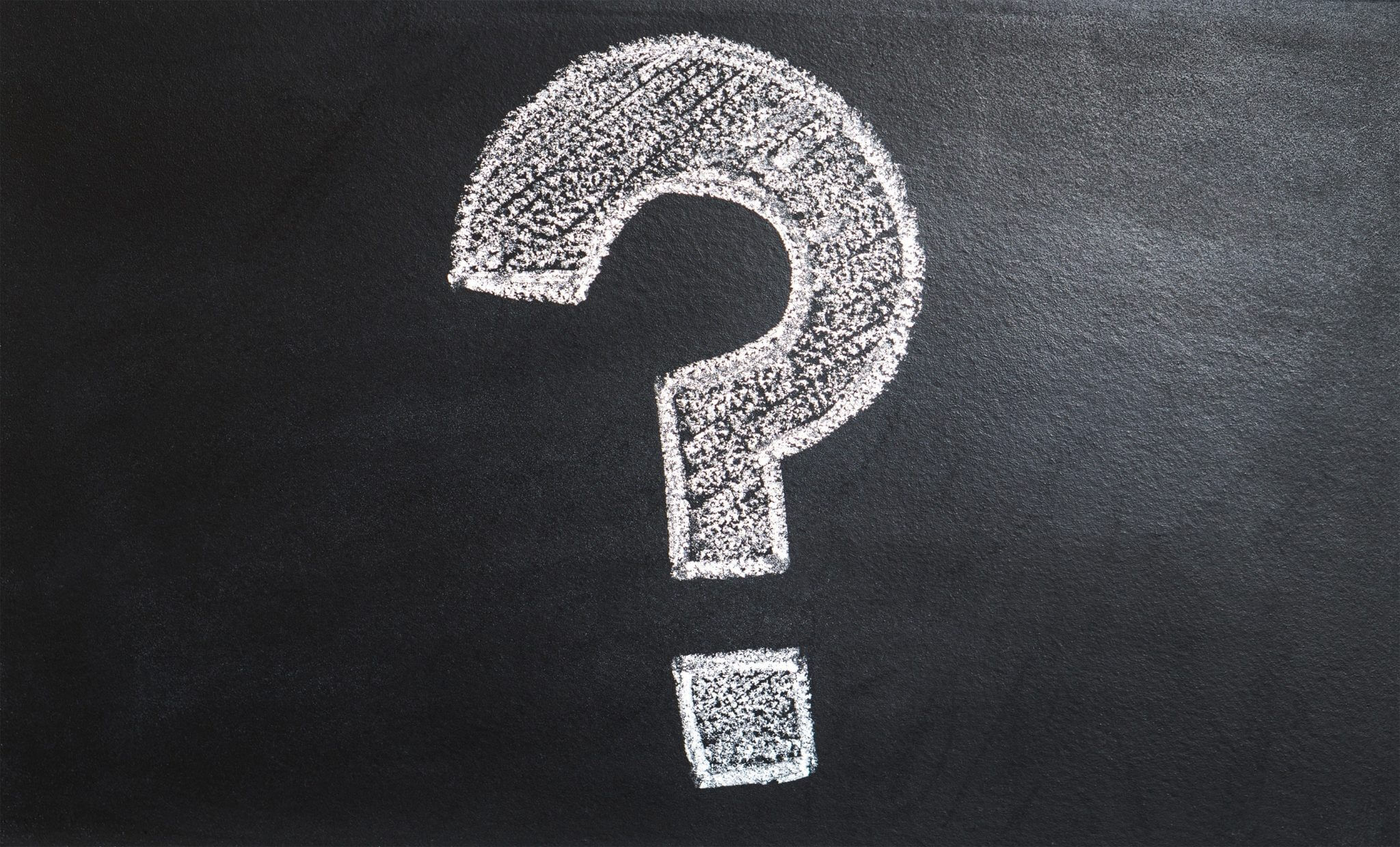 Large chalk question mark on a blackboard Large chalk question mark on a blackboard