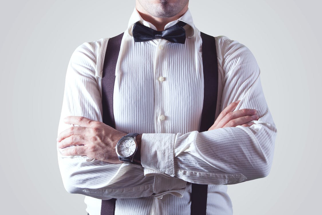 Guy wearing a longsleeve shirt and bow tie, dressed in business wear