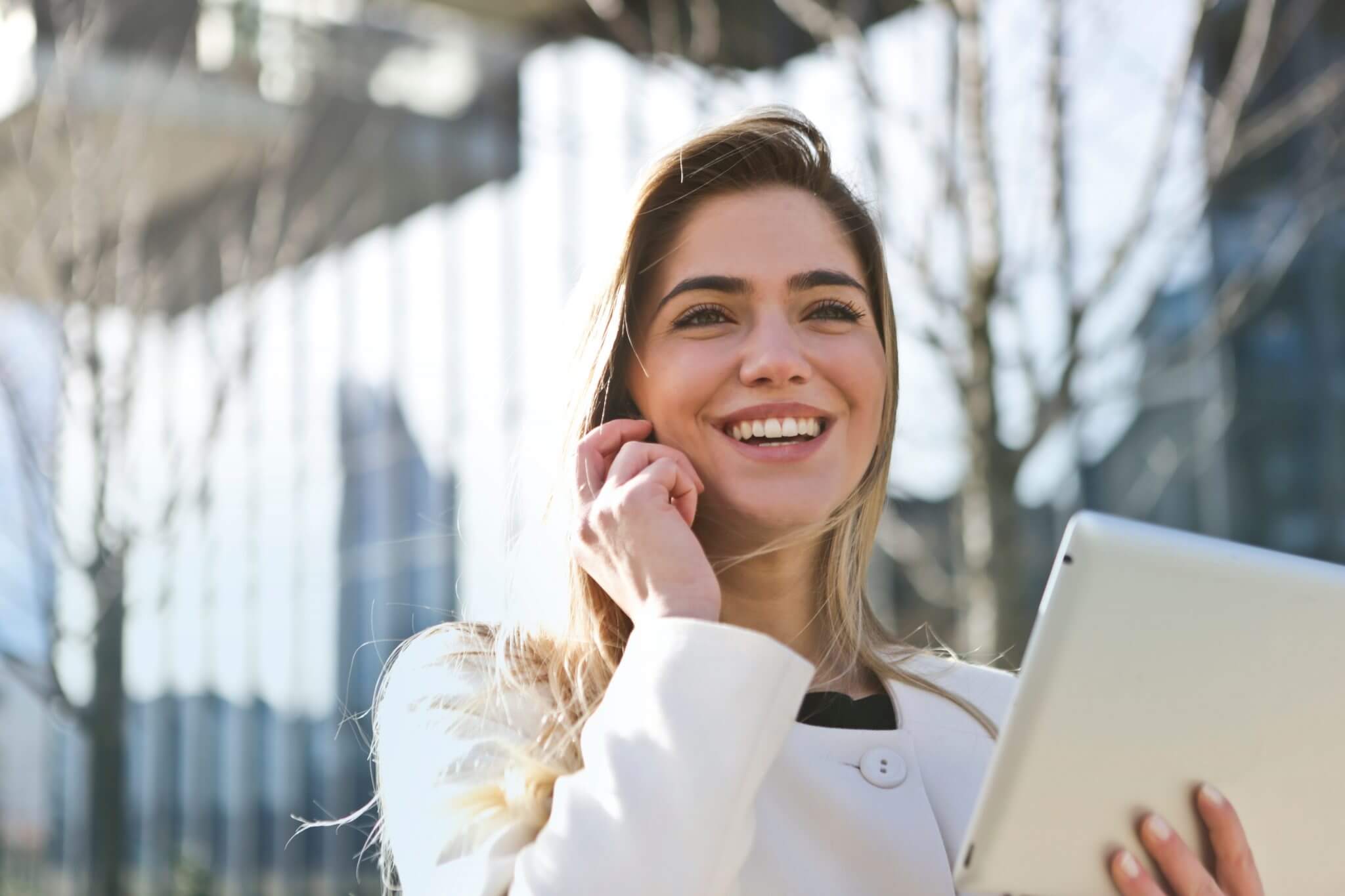 Businesswoman holding a set of documents speaking on the phone. Businesswoman holding a set of documents speaking on the phone.