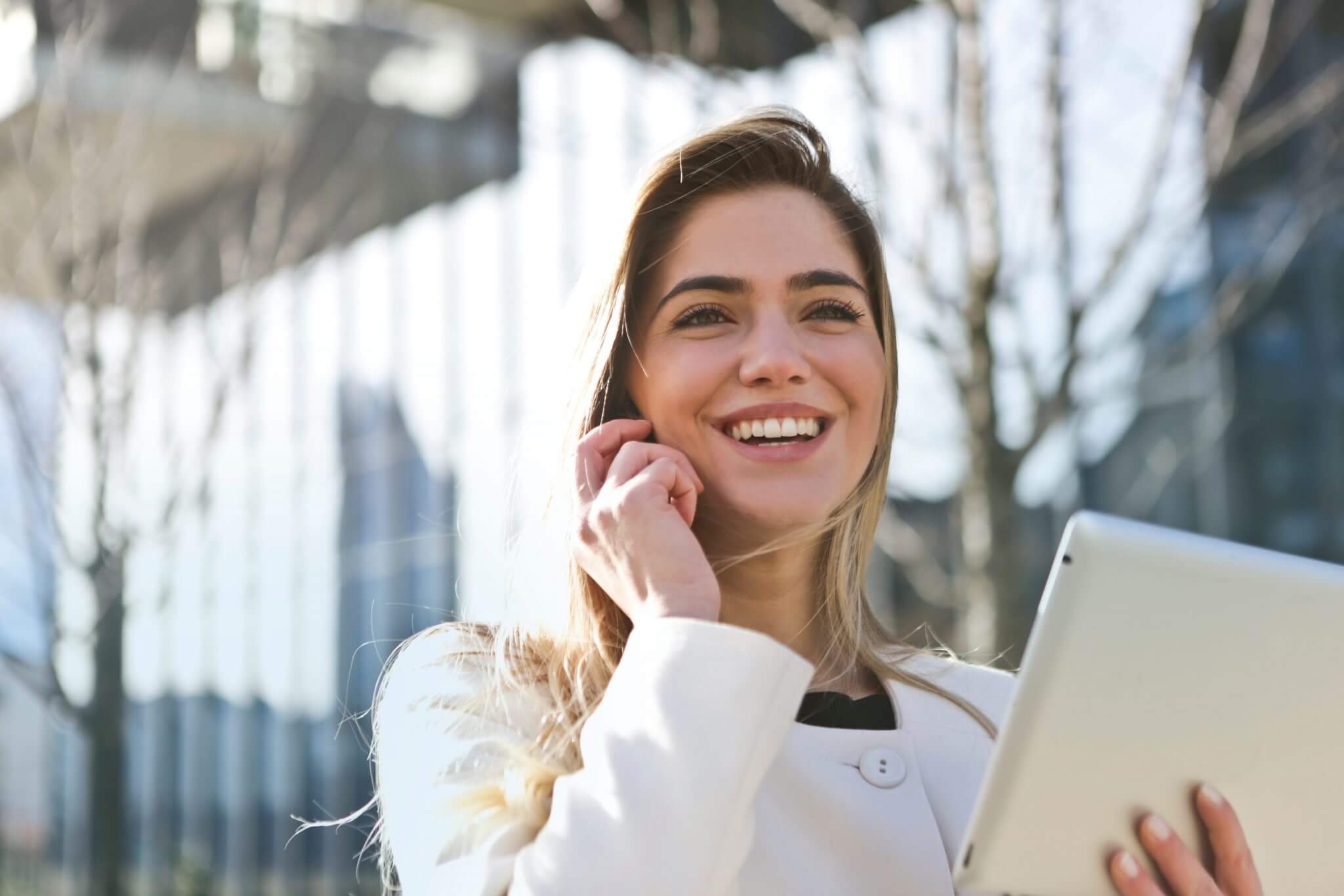 Businesswoman holding a set of documents speaking on the phone.