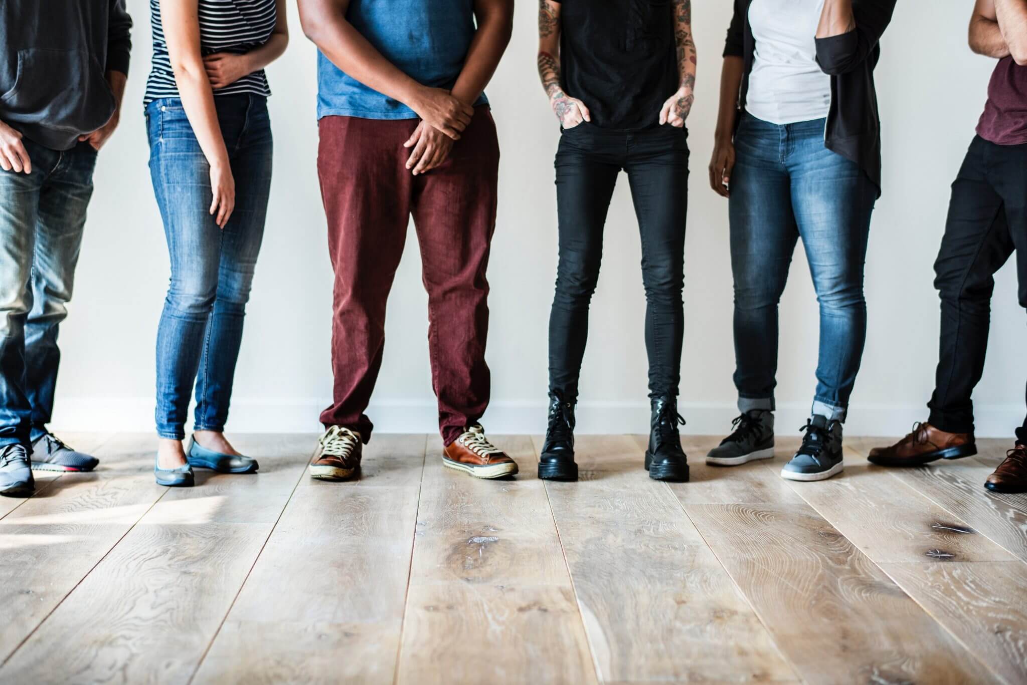 Young people standing in a row, the camera panned from the waist down. Young people standing in a row, the camera panned from the waist down.
