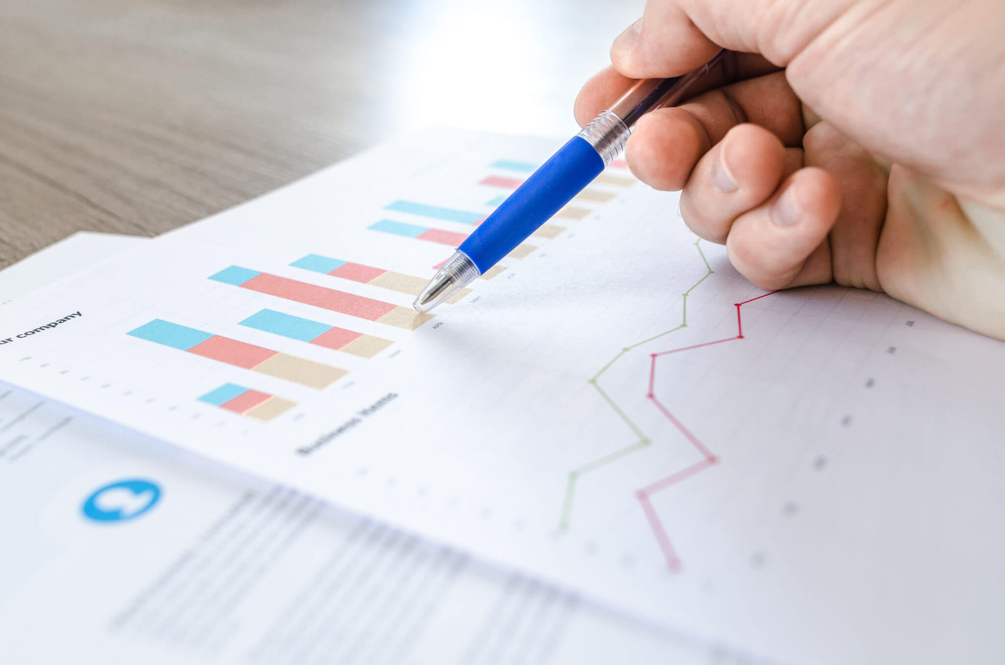 Man showing business graph on wood table Man showing business graph on wood table
