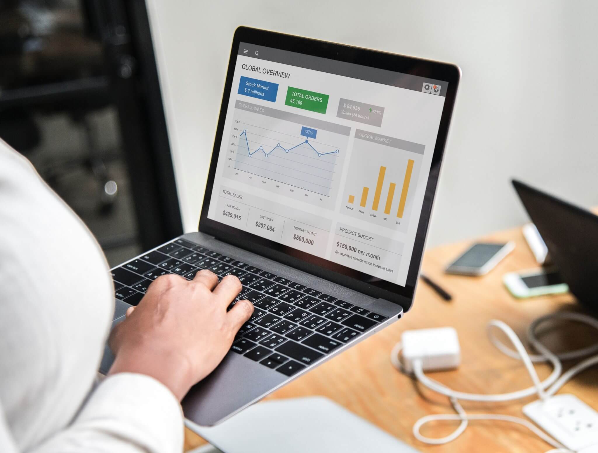 Person typing on a computer with facts and statistics.