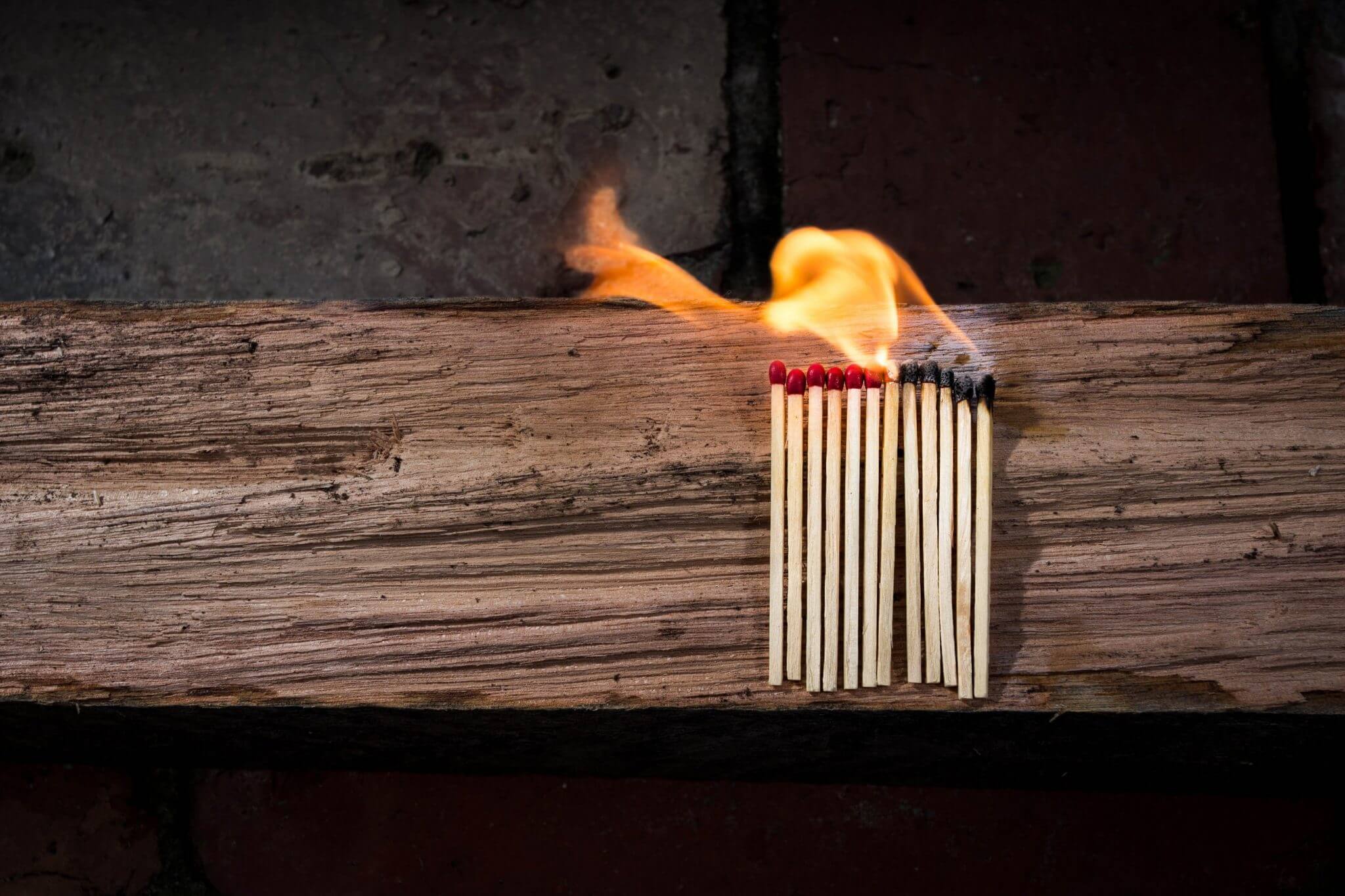 Bundle of matches catching fire from other lit matches.