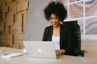 woman-in-black-blazer-sitting-by-the-table