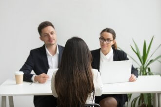 Headhunters interviewing female job candidate