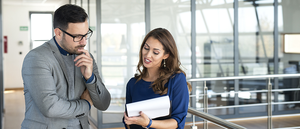 Two business people sharing ideas and working together on a solut