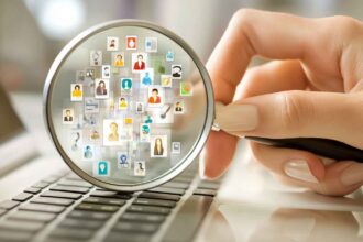 HR manager using a magnifying glass over abstract, colorful icons representing personality traits, symbolizing how personality assessment tools reveal hidden qualities.