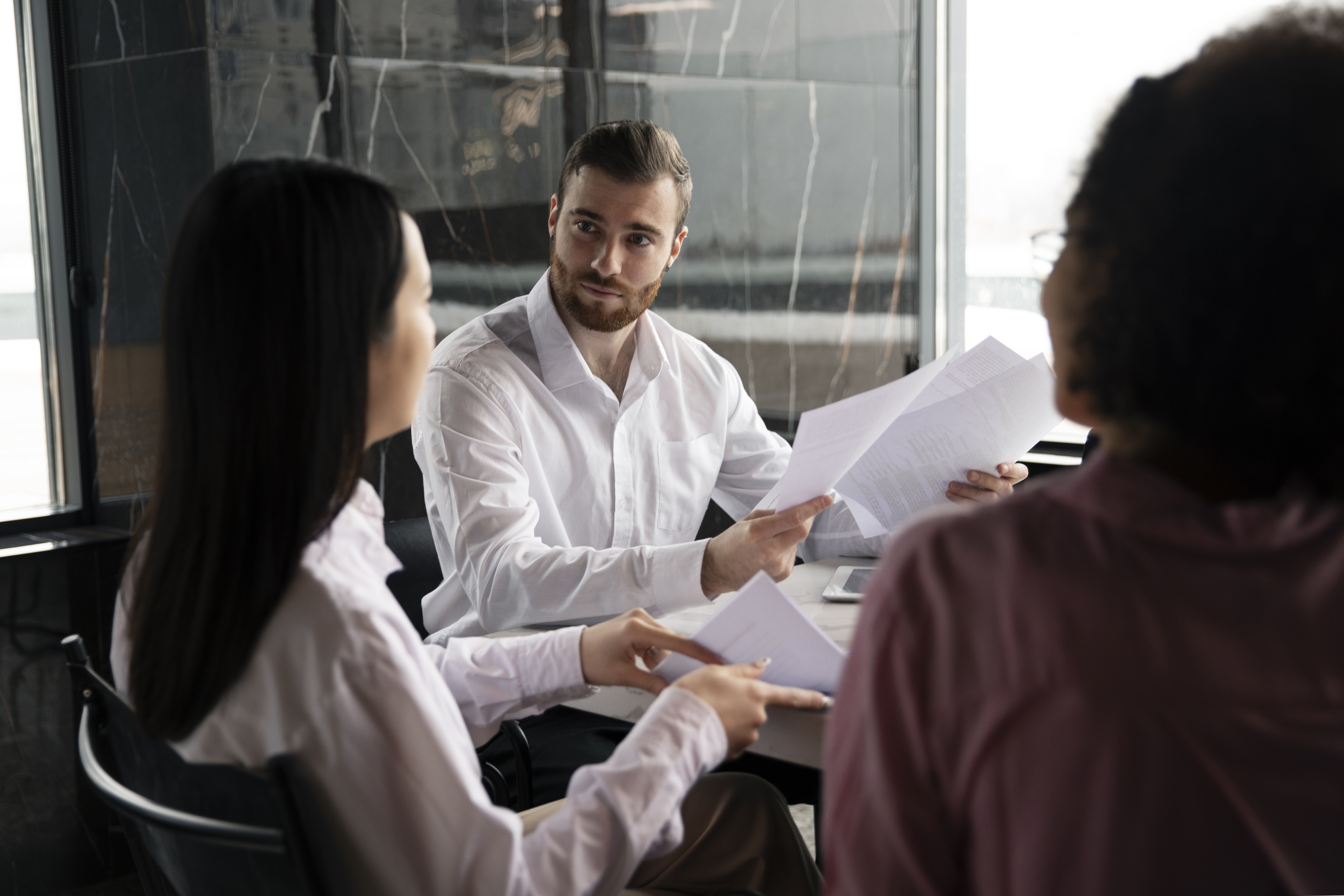 man-showing-his-workmates-documents