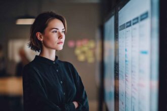 A recruiter at a large screen comparing multiple integrity assessment tools side by side