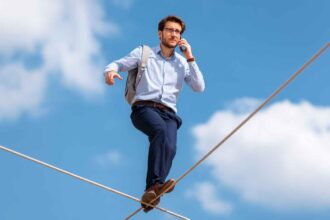 Telemarketer on a tightrope with phone, symbolizing resilience under cold calling pressure.