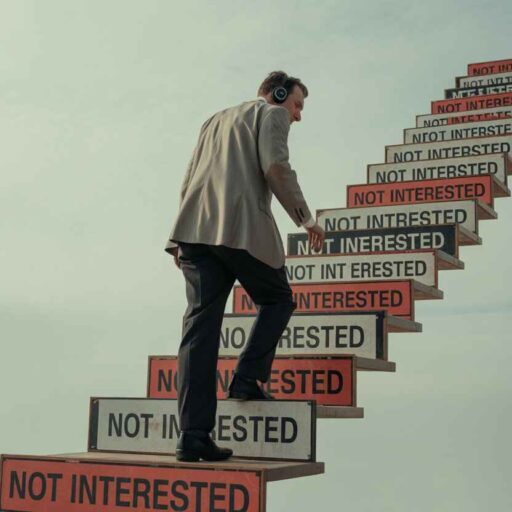 Rejections transforming into steps, symbolizing resilience and success in cold calling.