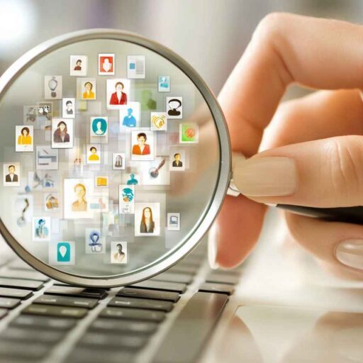 HR manager using a magnifying glass over abstract, colorful icons representing personality traits, symbolizing how personality assessment tools reveal hidden qualities.