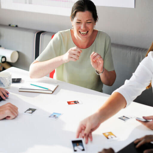 Colleagues laughing at photo across