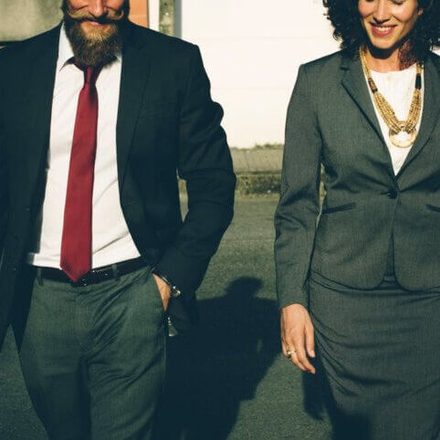 Man and woman in business attire walking next to each other