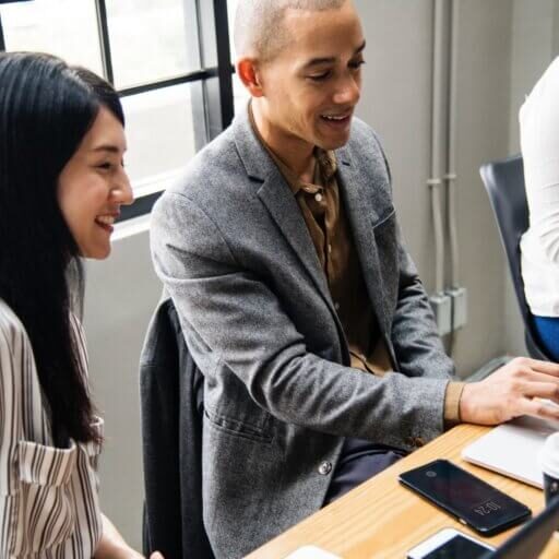 Employees in a conversation around a table.