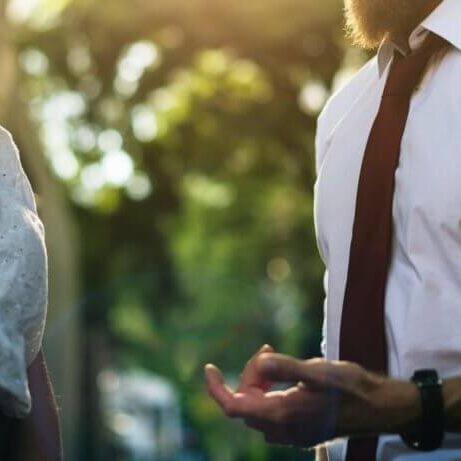 Two people talking to each other in a neutral environment.