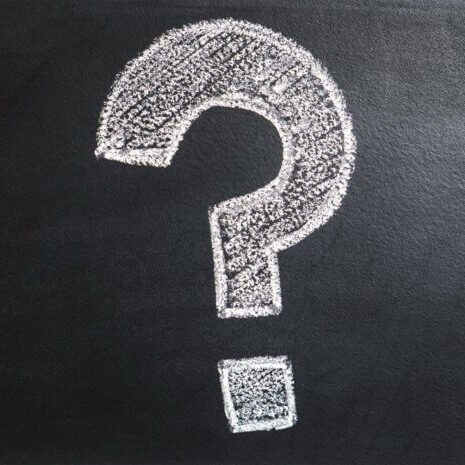 Large chalk question mark on a blackboard
