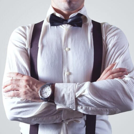 Guy wearing a longsleeve shirt and bow tie, dressed in business wear