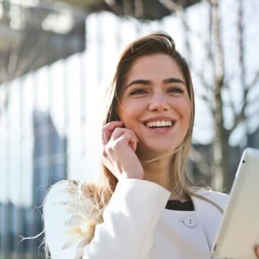 Businesswoman holding a set of documents speaking on the phone.