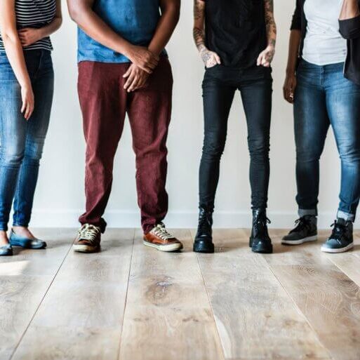 Young people standing in a row, the camera panned from the waist down.