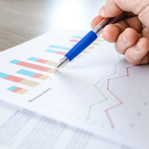 Man showing business graph on wood table
