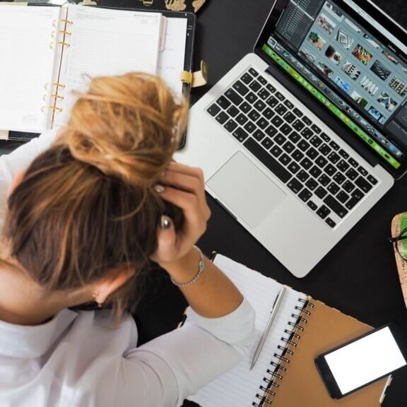 stressed out employee staring at her computer