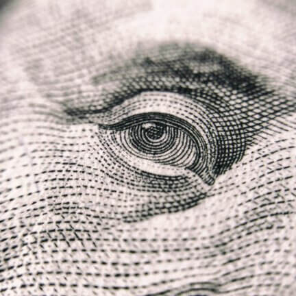 close up of bejamin franklin's eye on $100 bill