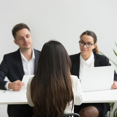Headhunters interviewing female job candidate