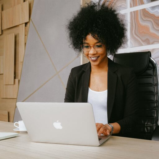 woman-in-black-blazer-sitting-by-the-table